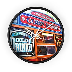 May include: A vintage-style clock featuring a colorful illustration of a food stand with the text "Little Red Wagon" and "Corn Dogs". The stand has a window with the text "Refreshing! Cold Drinks".
