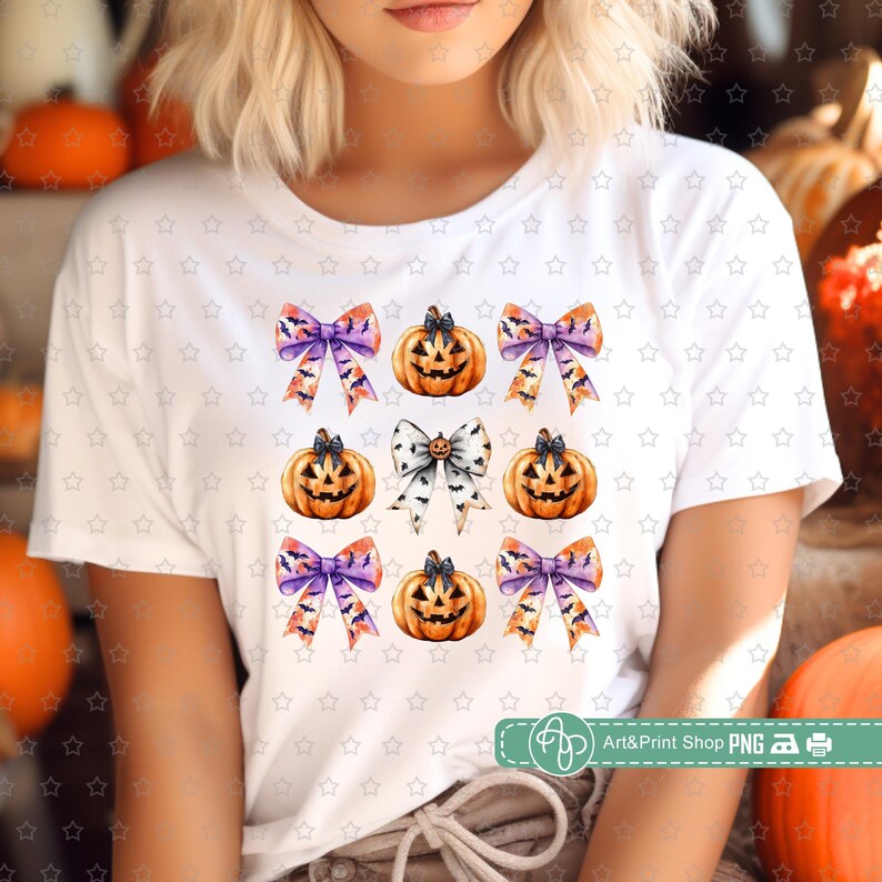 May include: A white t-shirt with a repeating pattern of orange and white jack-o'-lantern pumpkins with purple and orange bows with bats.