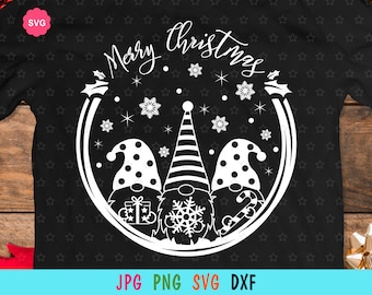 May include: A black t-shirt with a white design of three gnomes in a circle with the text "Merry Christmas" above them. The gnomes are wearing hats and have snowflakes around them.