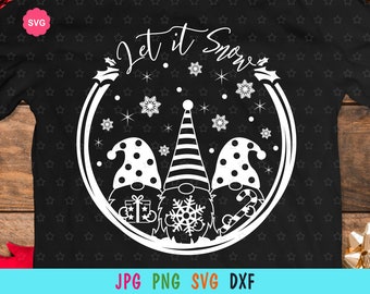 May include: A black t-shirt with a white circle design featuring three gnomes and the text "Let it Snow". The gnomes are wearing hats and holding a gift, a snowflake, and a candy cane.