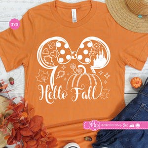 May include: Orange t-shirt with a white outline of a pumpkin, a bow, and the text "Hello Fall".