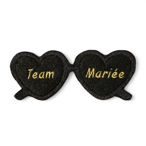 Peut inclure: Lunettes de soleil en forme de cœur en feutre noir avec broderie dorée "Team Bride".