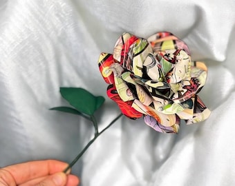 May include: A single red, yellow, and blue comic book rose with a green stem and leaves.