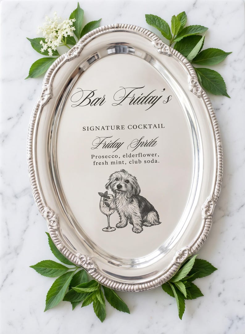 May include: An oval silver serving tray with an ornate rim featuring a printed menu for Bar Friday's Signature Cocktail, Friday Spritz, listing prosecco, elderflower, fresh mint, and club soda, accompanied by a black and white dog illustration.