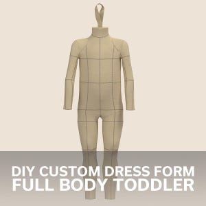 May include: A beige, full-body dress form for a toddler, with a grid pattern for marking measurements. It has a loop at the top for hanging.