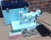 White Vintage Singer 221, 221K Portable Featherweight Sewing Machine with attachments.