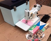 White Singer 221K Vintage Featherweight Sewing Machine with accessories and Instruction Manual