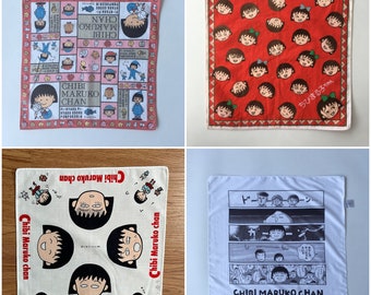 May include: Four square cotton handkerchiefs featuring the Japanese anime character Chibi Maruko Chan. Designs include a pink and white patterned handkerchief, a red handkerchief with repeating character faces, and two white handkerchiefs with character illustrations.