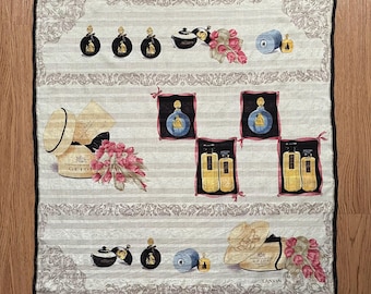 May include: Square white scarf with a black border, featuring perfume bottles, hats, and flowers. The design includes a striped background with decorative floral borders and the text "GELOT" and "LANVIN".