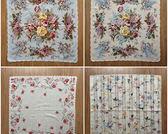 May include: Four different floral patterned handkerchiefs. The handkerchiefs are white with a variety of floral patterns in shades of pink, blue, and yellow.