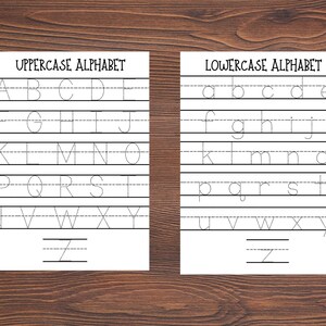 May include: Two white educational practice sheets featuring black dotted letters for handwriting exercises. The left sheet is titled UPPERCASE ALPHABET and the right sheet is titled LOWERCASE ALPHABET, both displaying the full alphabet on lined paper.