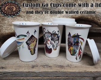 May include: Three ceramic go cups with lids. Each cup features a different colorful abstract design. The text "Custom Go Cups come with a lid and they're double walled ceramic" is visible at the top of the image.