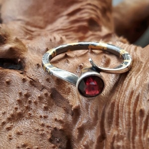 Silver ring with 24K gold inlay and faceted garnet