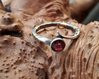 Silver ring with 24K gold inlay and faceted garnet