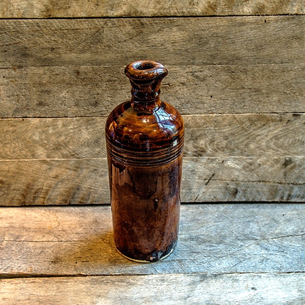 Large brown stoneware bottle