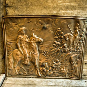 Antique metal fireplace cover