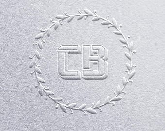 May include: A white embossed monogram with the letters "CB" surrounded by a wreath of leaves.