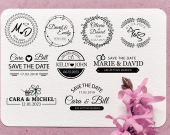May include: A collection of wedding save the date stamps with various designs and text. The stamps feature floral wreaths, hearts, and rings. The text includes names, dates, and phrases like "Save the Date" and "Are Getting Married".