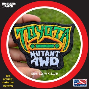 May include: A black embroidered patch with a green and yellow Toyota logo and the text "Mutant AWD". The patch is 4.2 inches wide and 3.1 inches high.