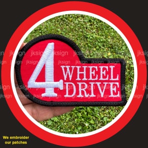 May include: Red and white embroidered patch with the number 4 and the text "WHEEL DRIVE".