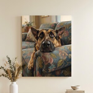 May include: A rectangular wall art print featuring a German Shepherd dog resting its chin on the arm of a floral patterned sofa. The dog has black and tan fur, pointed ears, and brown eyes. The artwork is displayed in a home interior setting.