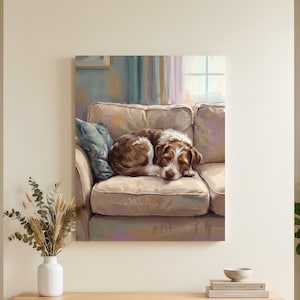 May include: A rectangular wall art print depicting a brown and white dog curled up on a beige sofa. The artwork features soft, painterly brushstrokes in muted tones of blue, purple, and cream, capturing a cozy indoor scene with a window in the background.