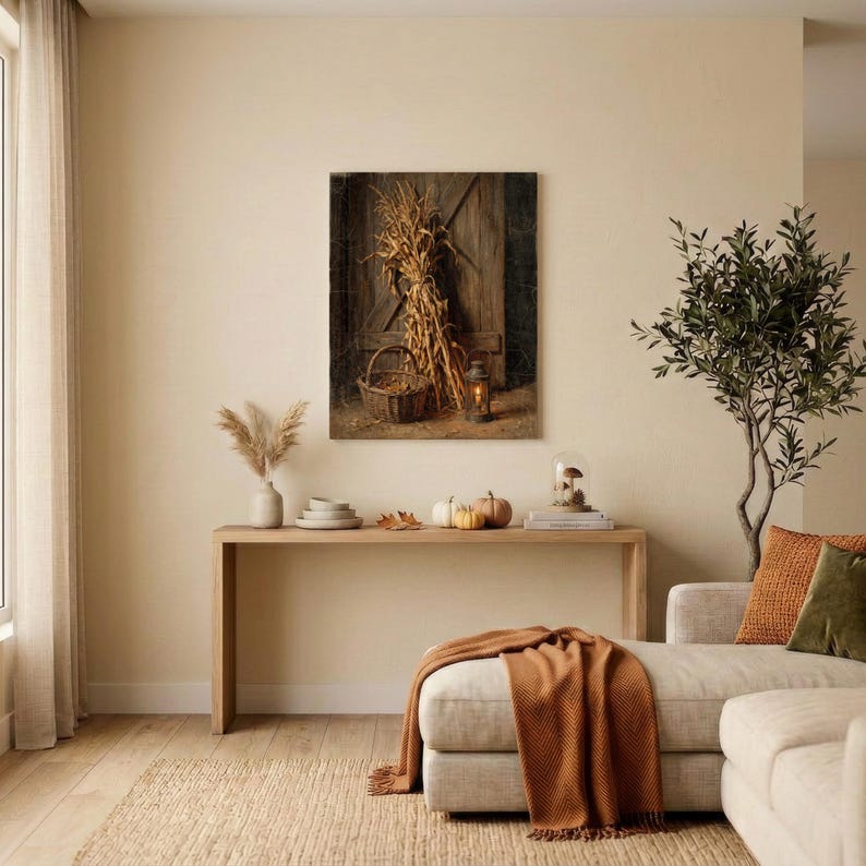 May include: A rectangular wall art print featuring a rustic wooden door background with a bundle of dried corn stalks, a woven wicker basket, and a small lit lantern. The color palette consists of warm brown, golden yellow, and dark wood tones.