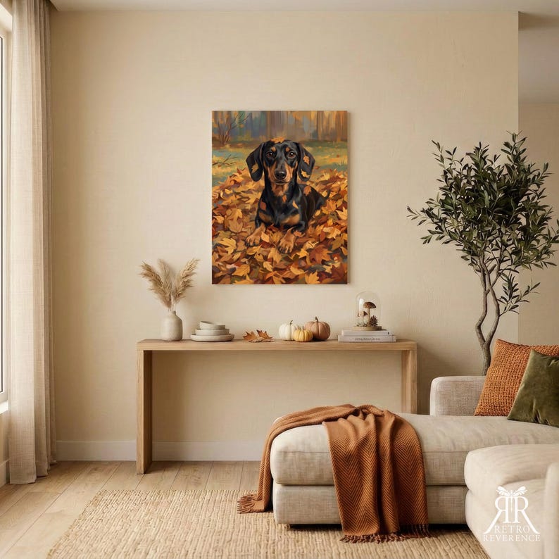 May include: A rectangular wall art print featuring a black and tan dachshund sitting in a pile of vibrant orange and yellow autumn leaves. The dog is positioned centrally, looking forward, with a blurred forest background in warm, earthy tones.
