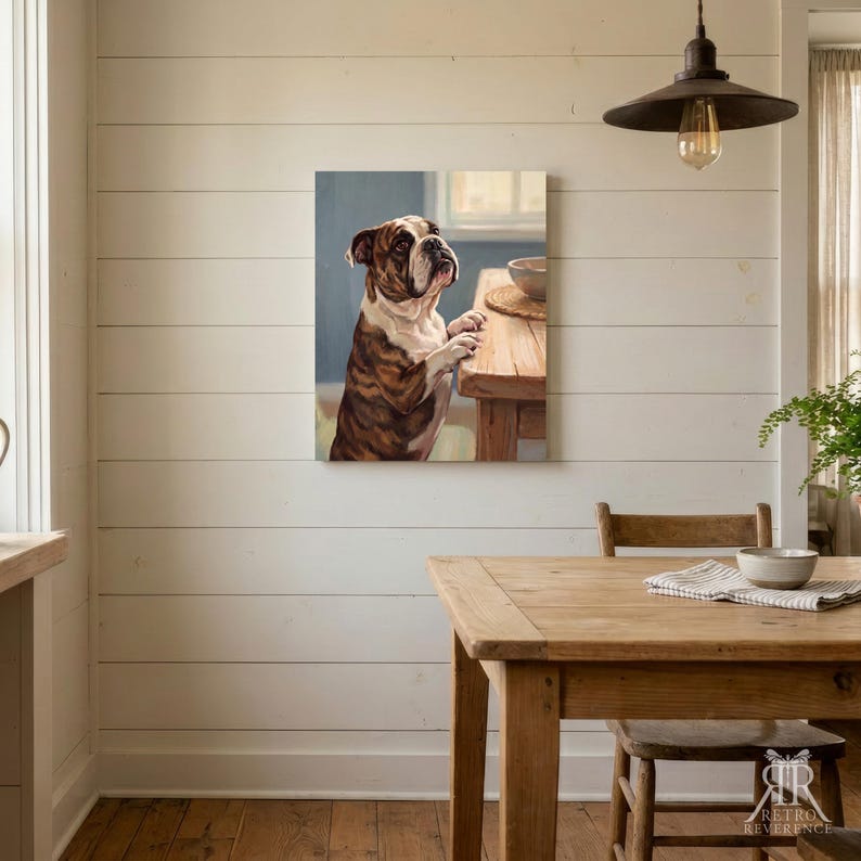 May include: A square wall art print featuring a brown and white bulldog standing with its front paws resting on a wooden table. The dog is looking towards the right side of the frame. The artwork is displayed on a white horizontal plank wall.