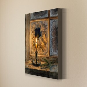 May include: A rectangular canvas wall art print depicting a lit candle in a metal holder on a wooden windowsill. The windowpane behind the candle features intricate frost patterns and a clear circular opening, with a small pine branch nearby.
