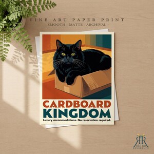 May include: A fine art paper print featuring a black cat sitting inside a brown cardboard box. The text reads: FINE ART PAPER PRINT, SMOOTH - MATTE - ARCHIVAL, CARDBOARD KINGDOM, Luxury accommodations. No reservation required. RETRO REVERENCE.
