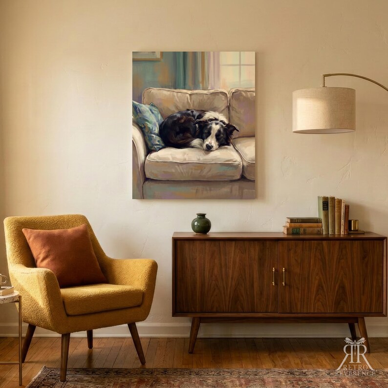 May include: A rectangular wall art print featuring a black and white dog curled up on a beige sofa. The artwork is displayed in a room with a yellow armchair, a wooden sideboard, a green vase, a stack of books, and a floor lamp with a beige shade.