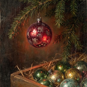 May include: A shiny, deep red glass Christmas bauble hangs from a green pine branch. Below, a wooden crate filled with straw contains several additional round glass baubles in various shades of green, gold, and silver with a weathered finish.