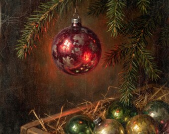 May include: A shiny, deep red glass Christmas ornament hangs from a green pine branch. Below, a wooden crate filled with straw contains several additional round glass ornaments in various shades of green, gold, and silver with a weathered finish.