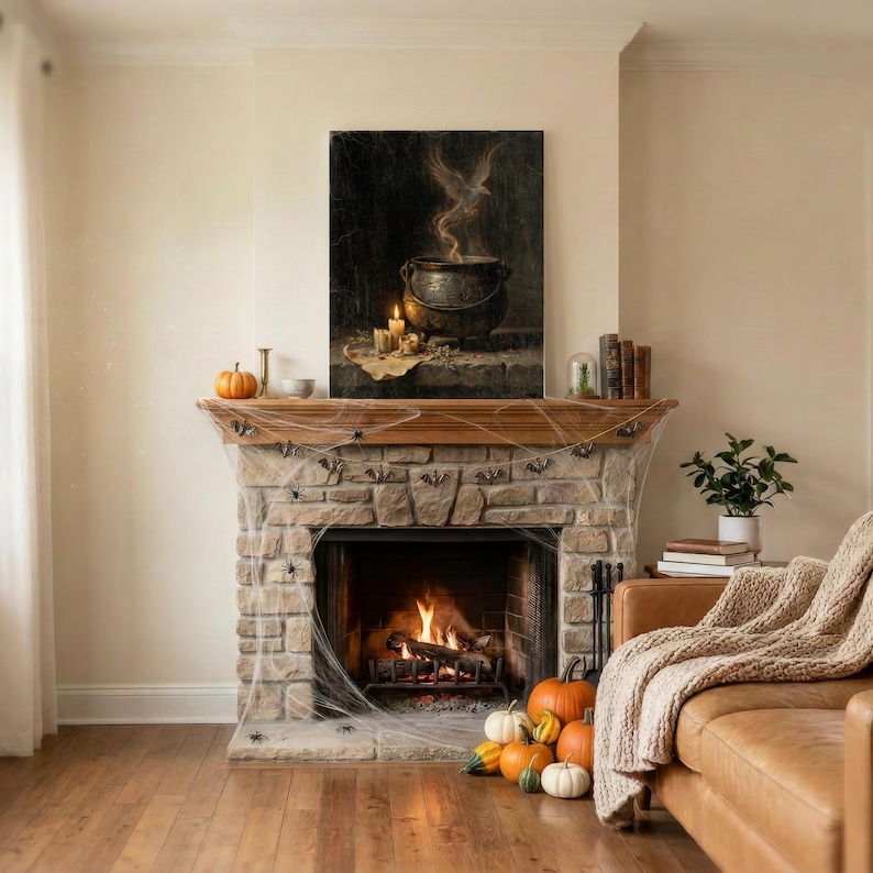 May include: A rectangular wall art print featuring a dark, atmospheric scene of a black cauldron with rising smoke and a ghostly bird silhouette, displayed above a stone fireplace decorated with artificial spiderwebs and orange pumpkins.