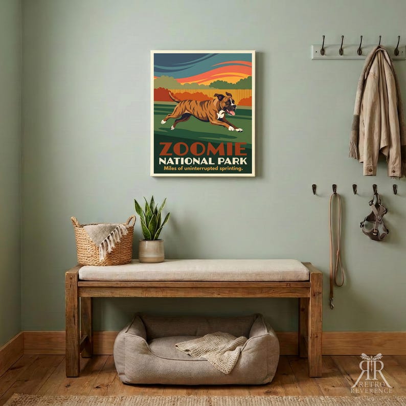 May include: A rectangular wall poster featuring a brown and white boxer dog running across a green field under a sunset sky. The text reads ZOOMIE NATIONAL PARK Miles of uninterrupted sprinting. The art style uses bold colors and flat shapes.