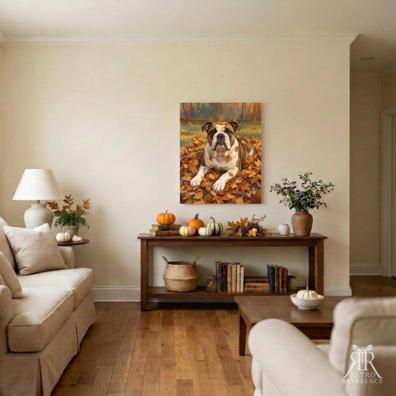 May include: A rectangular wall art print featuring a brown and white bulldog lying in a pile of autumn leaves. The dog has a wrinkled face and is positioned centrally within the frame, surrounded by vibrant orange, yellow, and brown foliage.