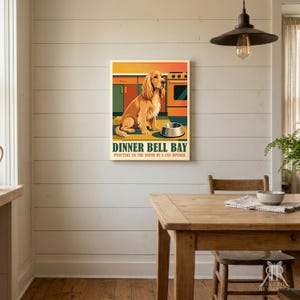 May include: A rectangular wall art print featuring a golden-colored dog sitting in a kitchen in front of a stove and a metal bowl. The text reads DINNER BELL BAY and Punctual to the sound of a can opener in dark green and red lettering.