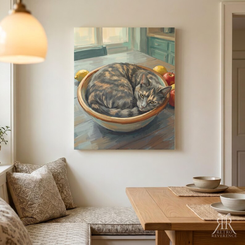 May include: A wall art print depicting a tortoiseshell cat curled up inside a large ceramic bowl filled with various fruits including lemons and apples. The artwork features a soft color palette and visible brushstrokes, capturing the cat resting.