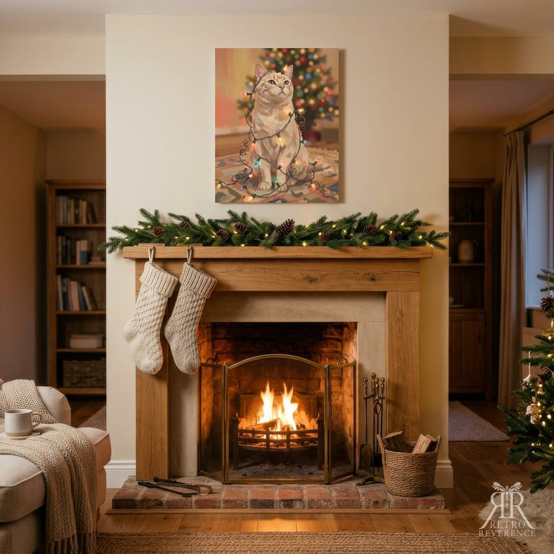 May include: A rectangular wall art print featuring a light-colored cat wrapped in colorful string lights, positioned above a wooden fireplace mantel. The mantel is decorated with a green pine garland, two cream-colored knit stockings, and a fire.