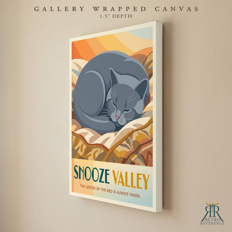 May include: A gallery wrapped canvas with a 3.8 cm depth featuring a graphic illustration of a grey cat curled up on a bed. The text reads SNOOZE VALLEY THE CENTER OF THE BED IS ALWAYS TAKEN. The background displays warm orange and yellow tones.
