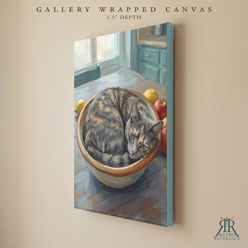 May include: A gallery wrapped canvas with a 1.5 inch depth featuring a painting of a tortoiseshell cat curled inside a ceramic bowl on a wooden table. The scene includes a yellow lemon and a red apple next to the bowl, set against a kitchen background.