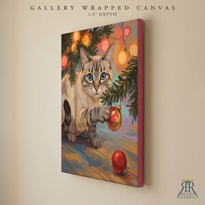 May include: A gallery wrapped canvas with a 1.5 inch depth featuring a painting of a light-colored cat with blue eyes playing with a red Christmas ornament hanging from a pine branch decorated with glowing orange and yellow string lights.