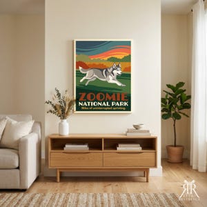 May include: A framed wall art print titled Zoomie National Park featuring a grey and white husky running across a green field under a sunset sky with orange and dark blue clouds. The text reads Zoomie National Park Miles of uninterrupted sprinting.