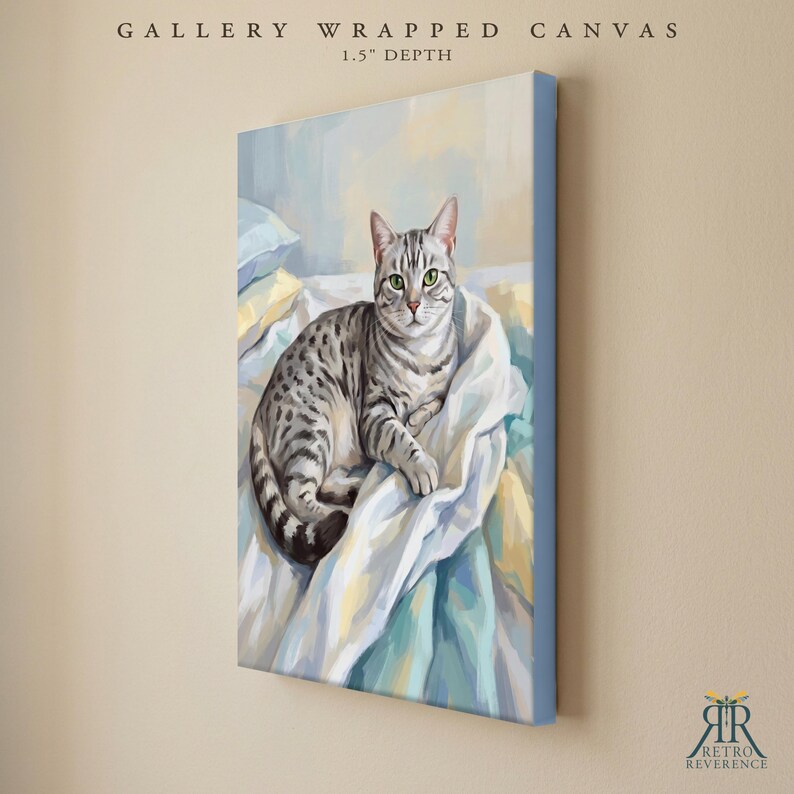 May include: A gallery wrapped canvas with a 1.5 inch depth featuring a painting of a grey tabby cat with green eyes resting on white and blue bedding. The text GALLERY WRAPPED CANVAS 1.5" DEPTH appears at the top, with a logo at the bottom.