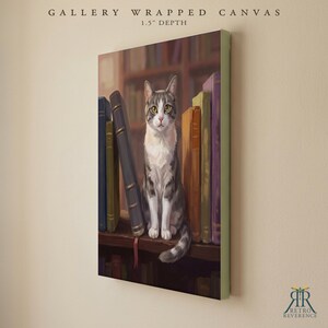 May include: A gallery wrapped canvas with a 1.5 inch depth featuring a painting of a grey and white tabby cat sitting on a wooden shelf between several upright books. The cat faces forward with yellow eyes, surrounded by books in shades of blue, green, brown, and purple.