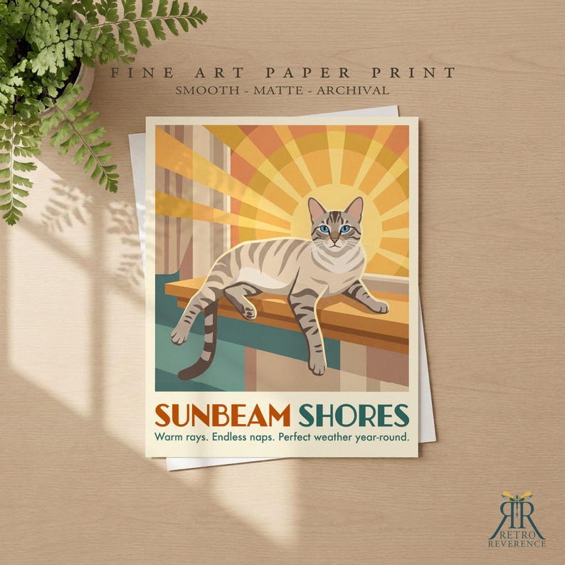 May include: A fine art paper print featuring a light brown tabby cat resting on a ledge against a yellow sunburst background. The text reads SUNBEAM SHORES, Warm rays. Endless naps. Perfect weather year-round. FINE ART PAPER PRINT.