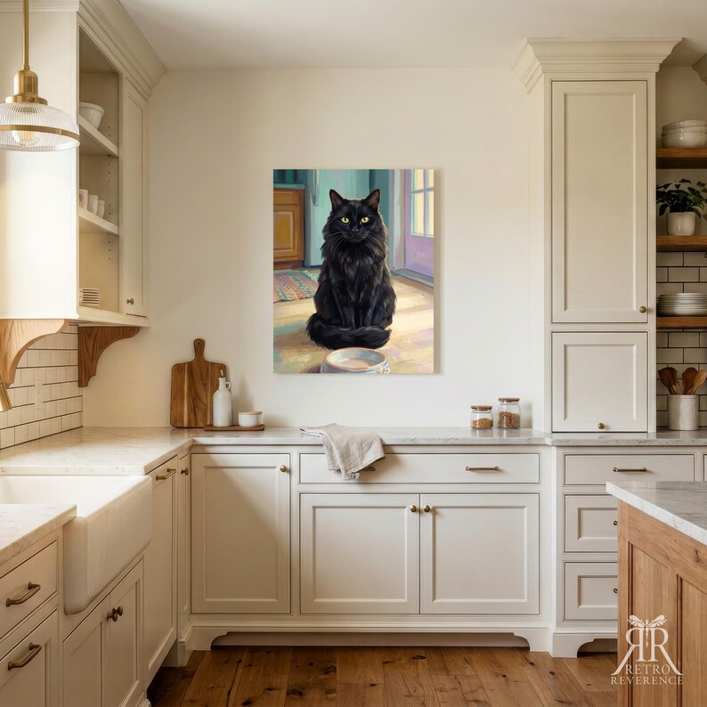 May include: A rectangular wall art print featuring a fluffy black cat with bright yellow eyes sitting on a light-colored floor in front of a bowl. The cat is positioned in the center of the artwork, which is displayed on a kitchen wall.