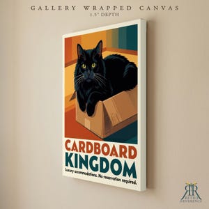 May include: A gallery wrapped canvas with a 1.5 inch depth featuring a black cat sitting in a cardboard box. The print includes the text CARDBOARD KINGDOM and Luxury accommodations. No reservation required. The background has orange and teal stripes.