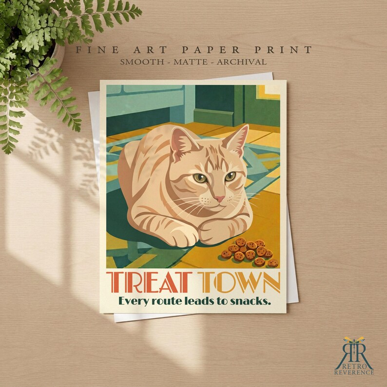 May include: A fine art paper print featuring a tan tabby cat resting on a patterned floor with a small pile of treats. The text reads TREAT TOWN and Every route leads to snacks. The print is smooth, matte, and archival quality.